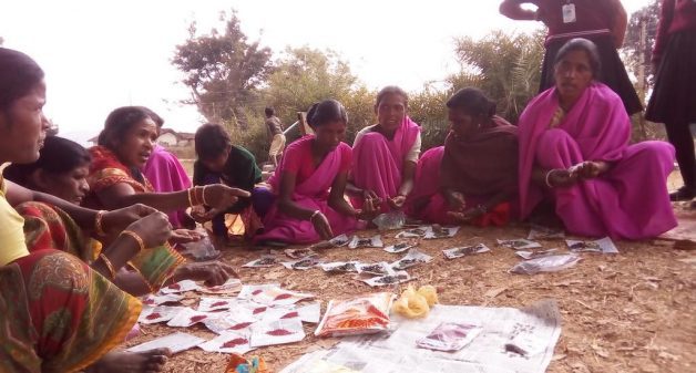 Women of self-help group in Ghagra village of Gumla district in Jharkhand distributing kitchen garden seeds among themselves. (Photo by Soumi Kundu)