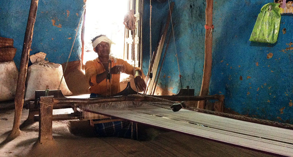 Pata saree weaver Sonadhar Das working on his wooden pit loom