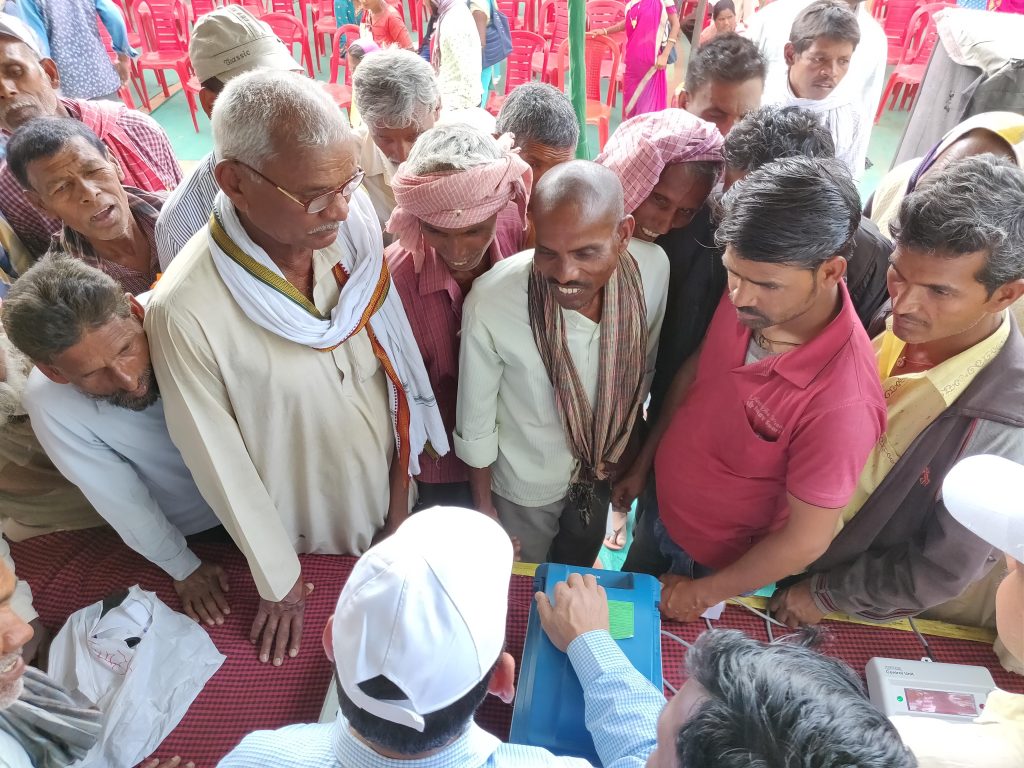 People interact with district officials about government schemes in Jharkhand.